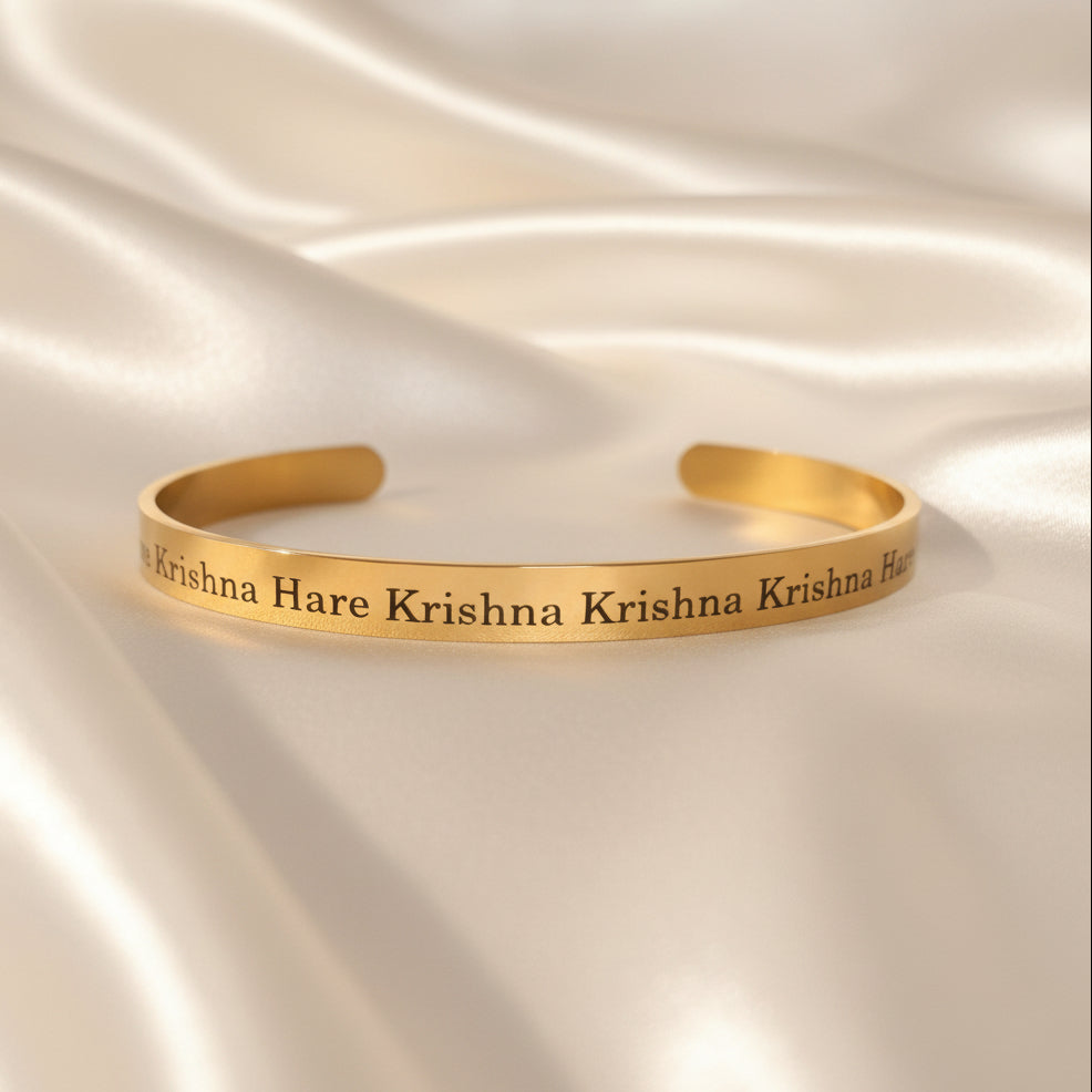Gold bracelet with 'Hare Krishna ' text on a white background